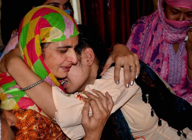 Wife Jaswinder Kaur (L) and daughter Sandeep Kaur of Naib Subedar Satnam Singh mourn after he was killed during the face-off between Indian and Chinese troops in Ladakh's Galwan Valley, at his native village Vhoj raj in Gurdaspur district, Thursday, June 18, 2020. (PTI Photo)(